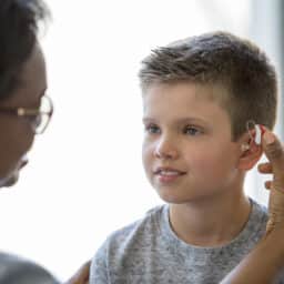 Young boy is fitted with hearing aid