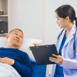 Man in hospital talks to doctor