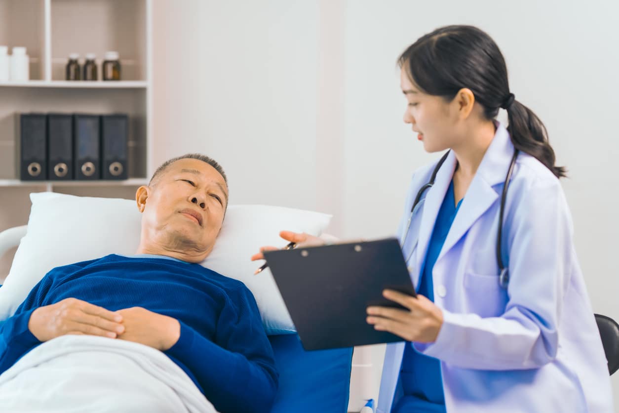 Man in hospital talks to doctor