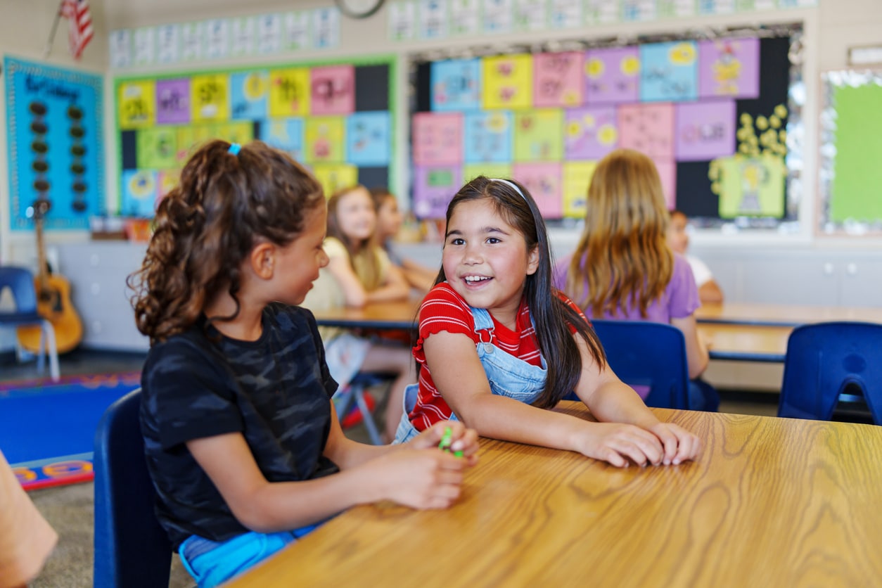 Young Girls Talking in the Classroom.